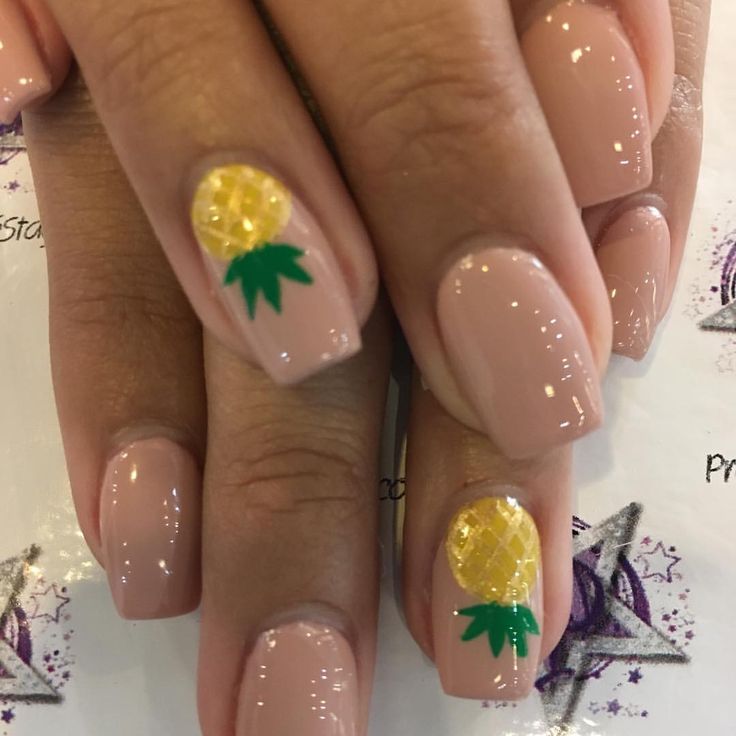 Tropical-Inspired Nail Design: Soft Nude Base with Playful Pineapple Accents.