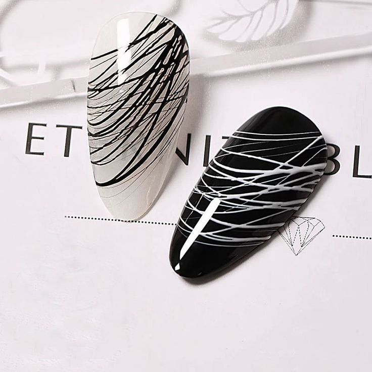 Elegant Monochromatic Nail Design with Striking Black and White Swirls