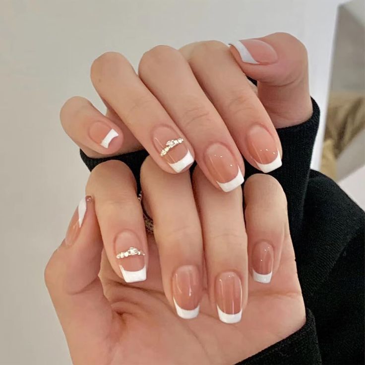 Timeless Elegant French Tip Manicure with Glamorous Embellishments.