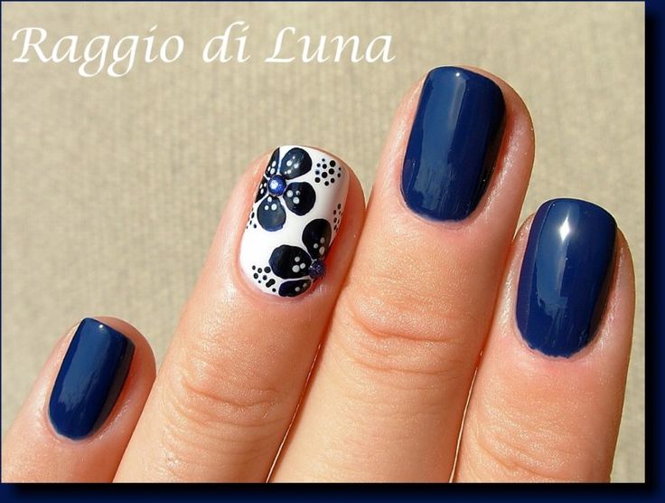 Elegant Dark Blue Nail Design with White Floral Accents.