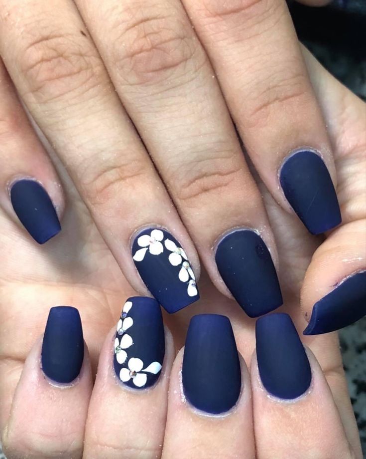 Chic Navy Matte Nails with Delicate Floral Accents for a Polished Look.