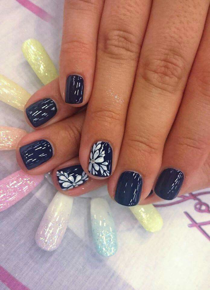 Elegant Navy and White Floral Nail Design with Shimmering Pastel Accents