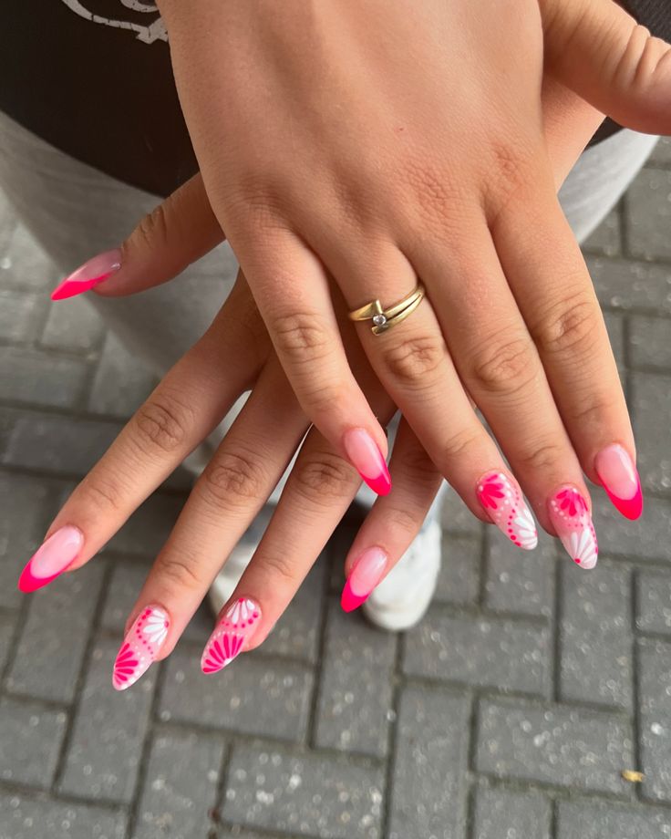 Trendy Vibrant Pink French Manicure with Intricate Floral and Abstract Patterns.