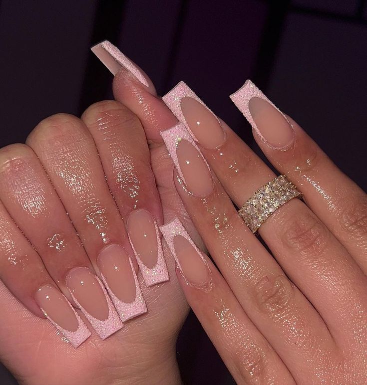 Chic and Glamorous Acrylic Nails: Trendy Long Square Shapes with Soft Almond Tips in Pink and Nude.