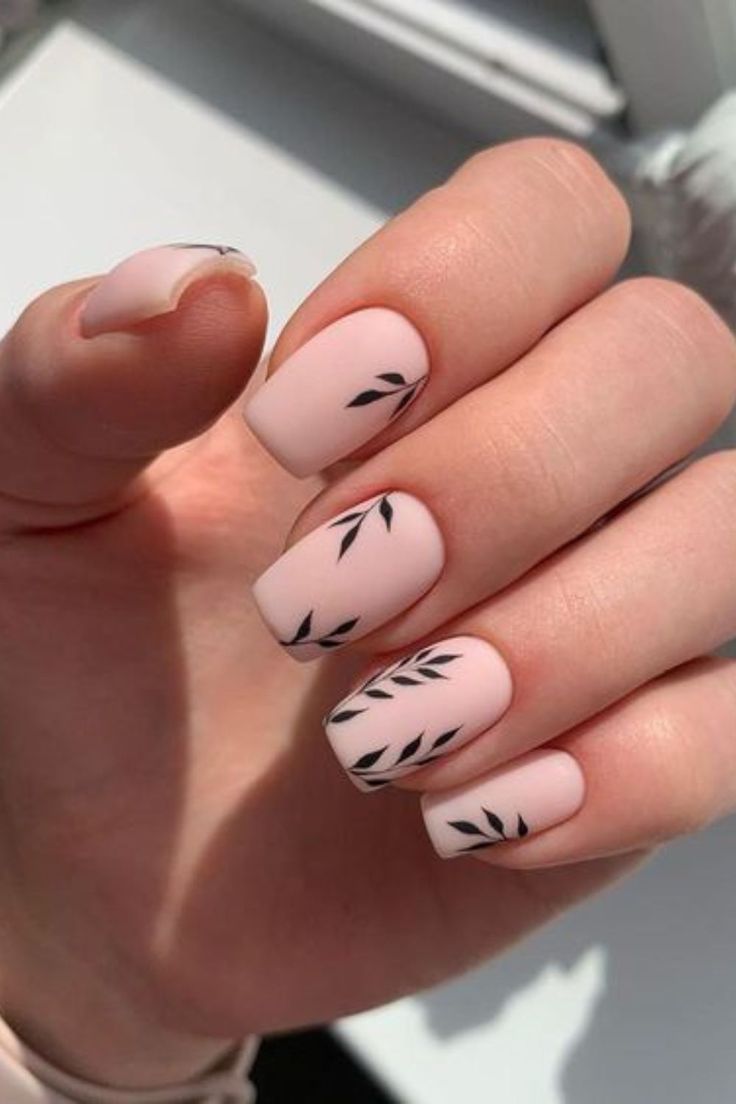 Chic Soft Pink Matte Nails with Delicate Black Leaf Motifs