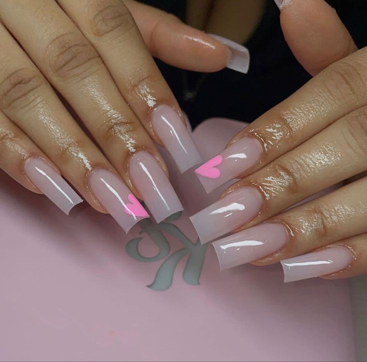 Chic Soft Pink Long Nails with Heart Accents for Versatile Elegance.