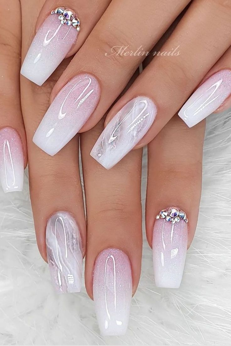 Sophisticated Ombre Nail Design with Marble Accents and Sparkling Tips for Special Occasions.