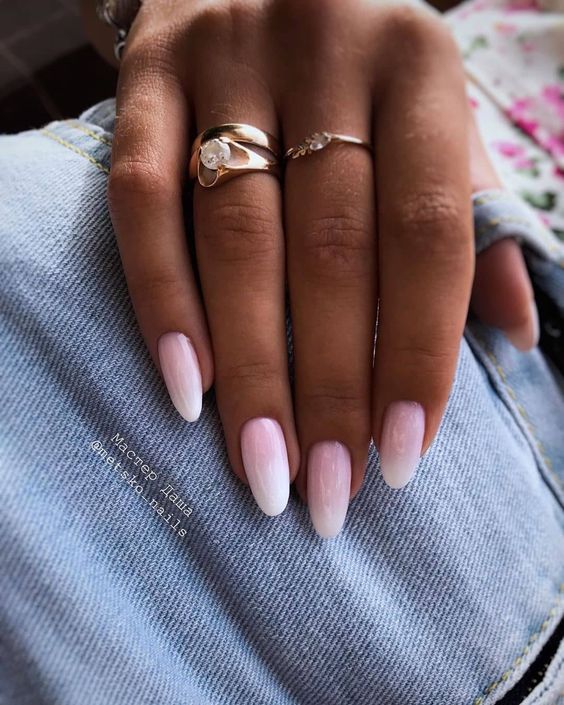 Chic Ombre Pink-White Almond Nails with Glossy Finish and Subtle Rings.