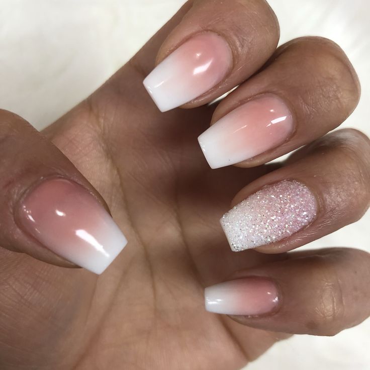 Elegant Ombre Nail Design: Soft Pink to White Gradient with Sparkling Accent.