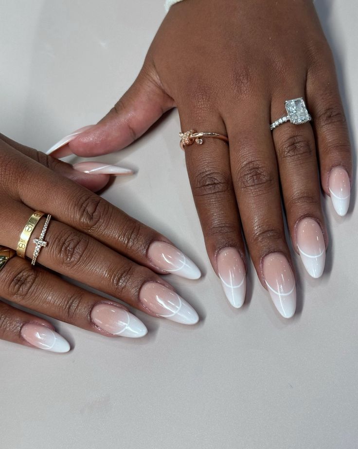 Sophisticated Long Almond Nails: Classic French Tip with Soft Pink and Delicate Ring Accents