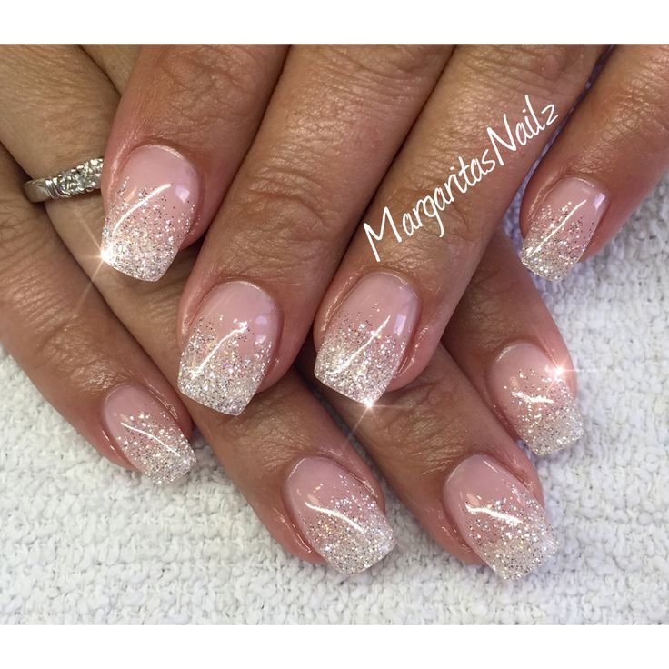 Sophisticated Glitter Ombre Nail Design: Soft Pink to Shimmering Silver Tips.