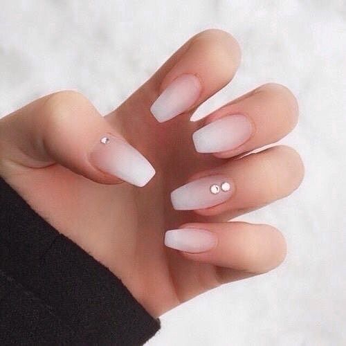 Chic Ombre Nails: A Glamorous White-to-Translucent Design with Rhinestone Accents.