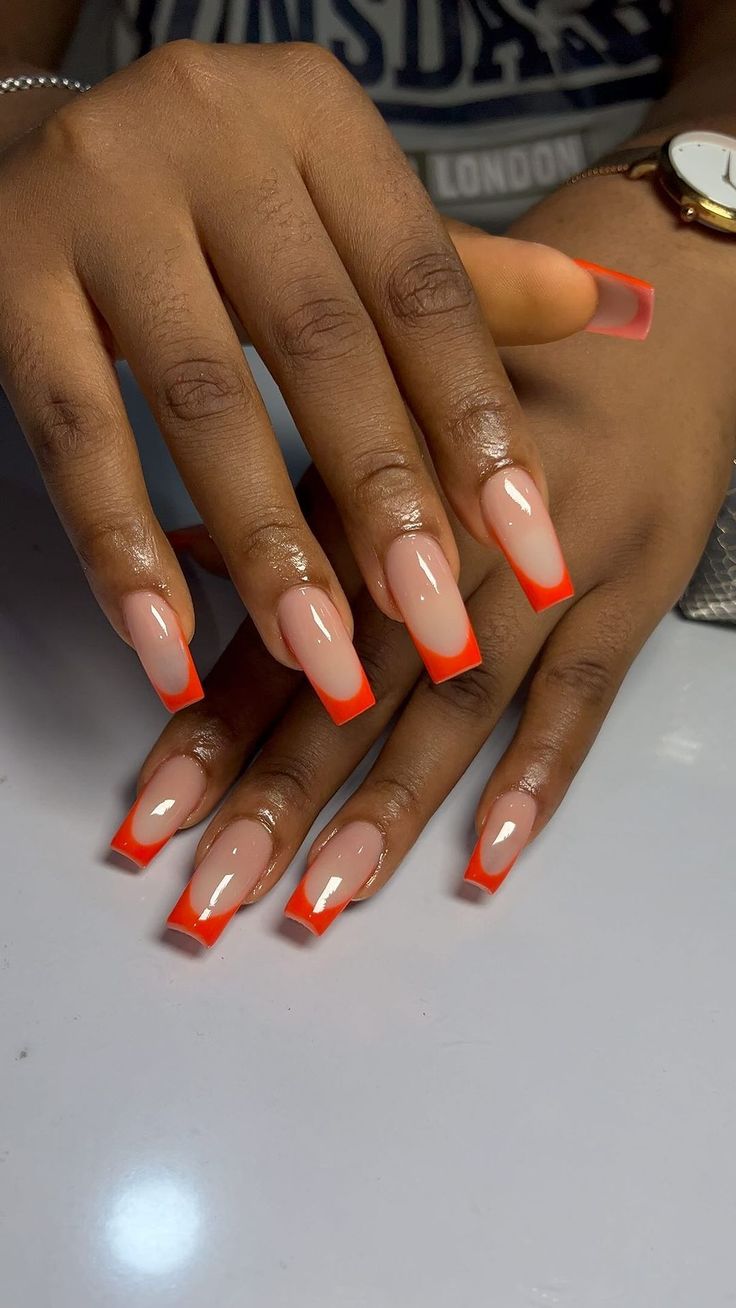 Trendy Vibrant Nail Design: Elegant Nude Base with Bold Orange Tips