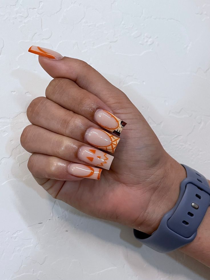 Elegant Autumn-Inspired Nail Design with Pumpkin Motifs in Nude and Orange Tones