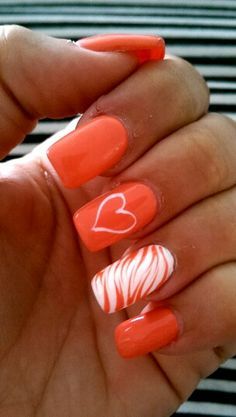 Playful Vibrant Coral Nail Design with Heart and Swirl Patterns for a Cheerful Style.