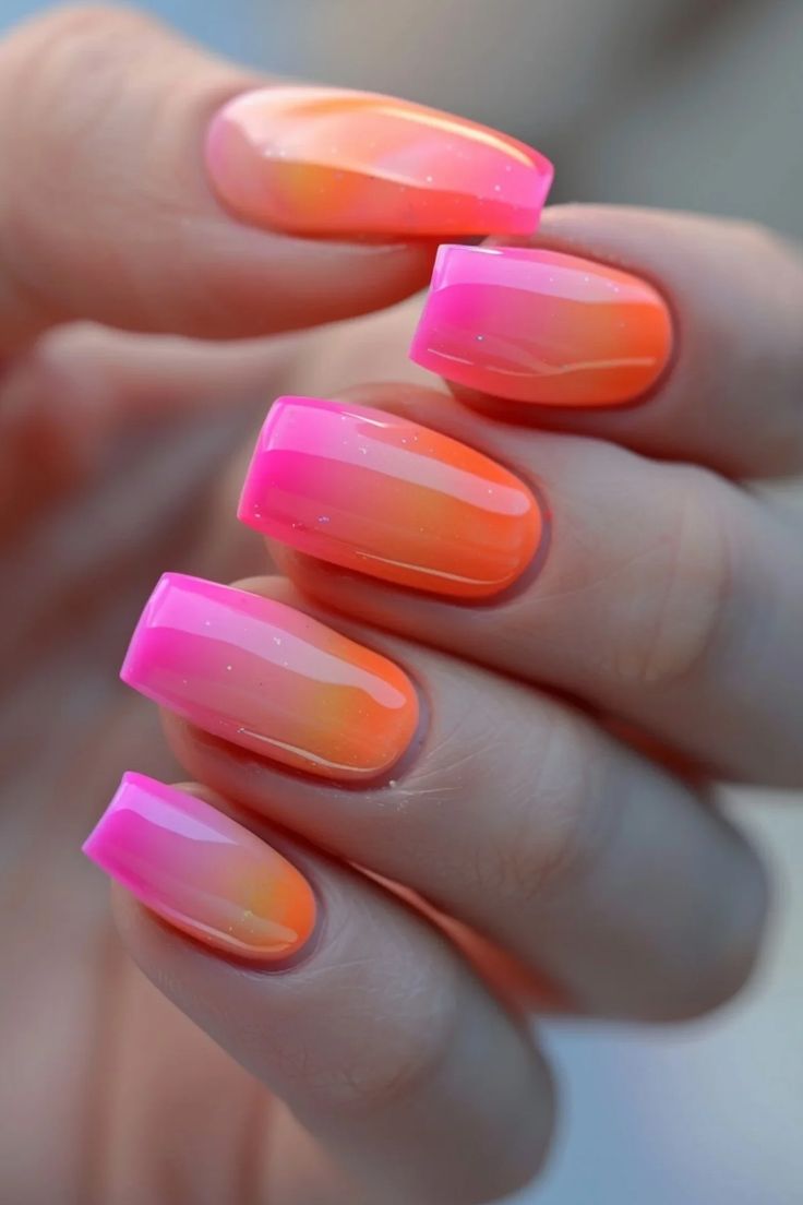 Vibrant Pink and Orange Ombre Nail Design with Glossy Finish and Bold Lines for a Playful Summer Look.