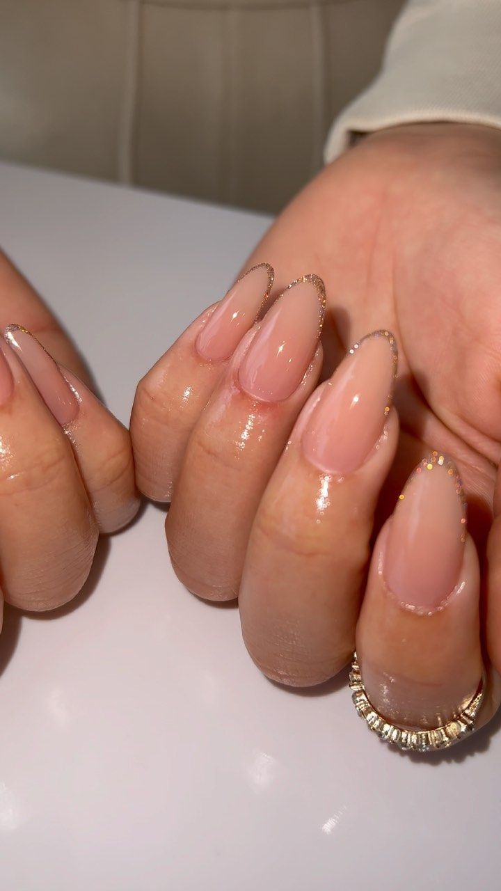 Sophisticated Almond-Shaped Nails with Soft Nude Base and Delicate Gold Tips.