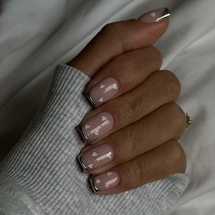 Chic Nude Nail Design with Minimalist White Patterns and Metallic Silver Tips.