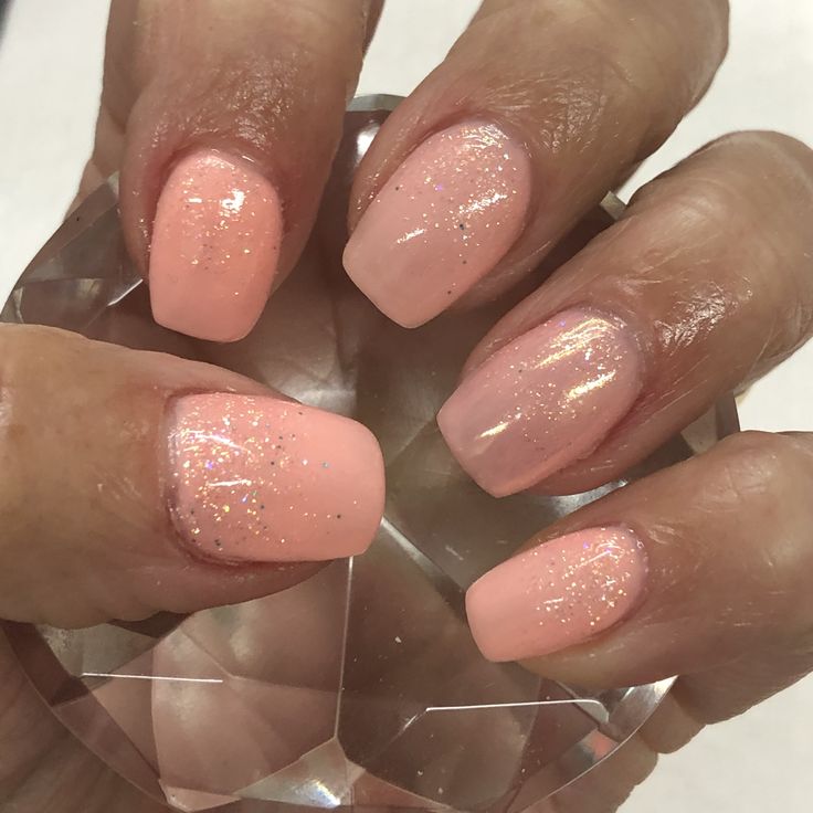 Charming Soft Pink Gradient Nails with Glitter Accents for Elegant, Versatile Style.