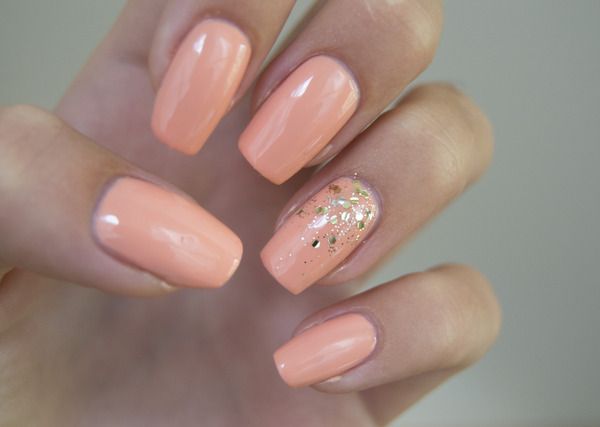 Chic Glossy Peach Nail Design with Sparkling Gold Glitter Accent