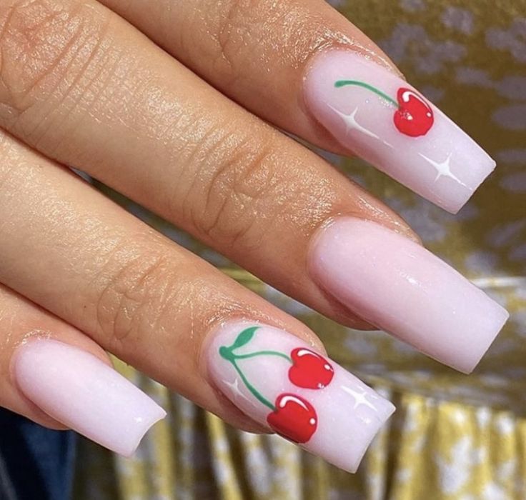 Playful Summer Chic: Soft Pink Nails Adorned with Whimsical Red Cherries and Sparkling Accents.