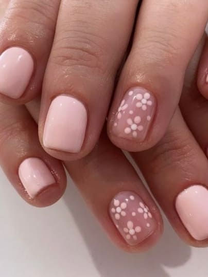 Elegantly Feminine Soft Pink Nail Design with Charming Floral Accent