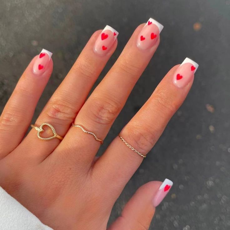 Chic Valentine Nail Design: Light Pink Base with White Tips and Red Heart Accents