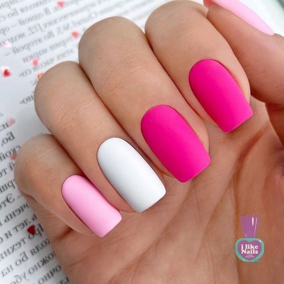 Playful Matte Nail Design with a Chic Mix of Soft and Vibrant Pinks and Crisp White.