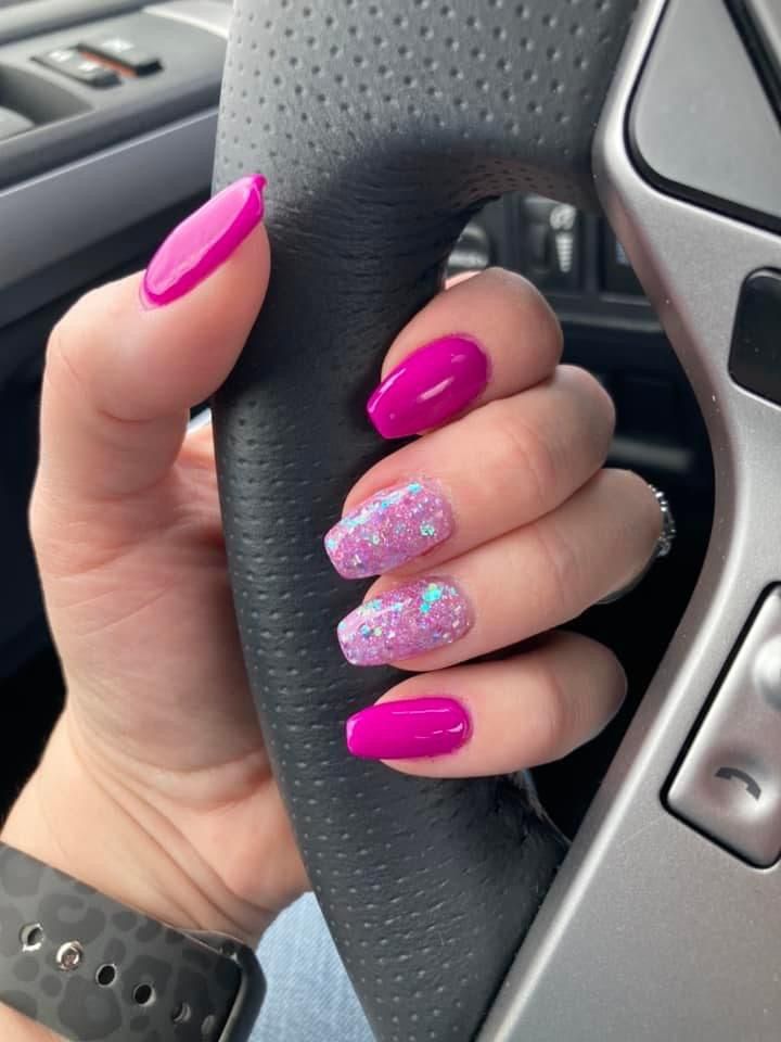 Bold Vibrant Pink Nails: A Playful Blend of Glossy Color and Glitter Accents.