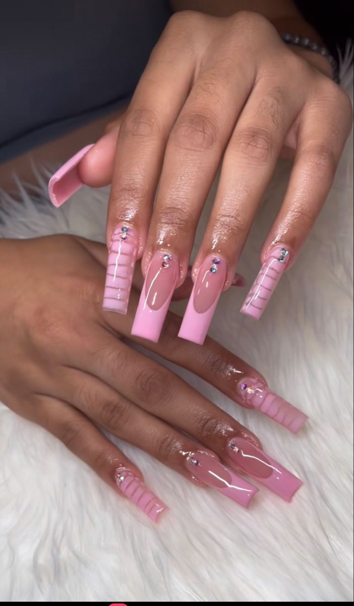 Glamorous Elegant Pink Nail Design with Long Acrylic Tips and Gemstone Accents.