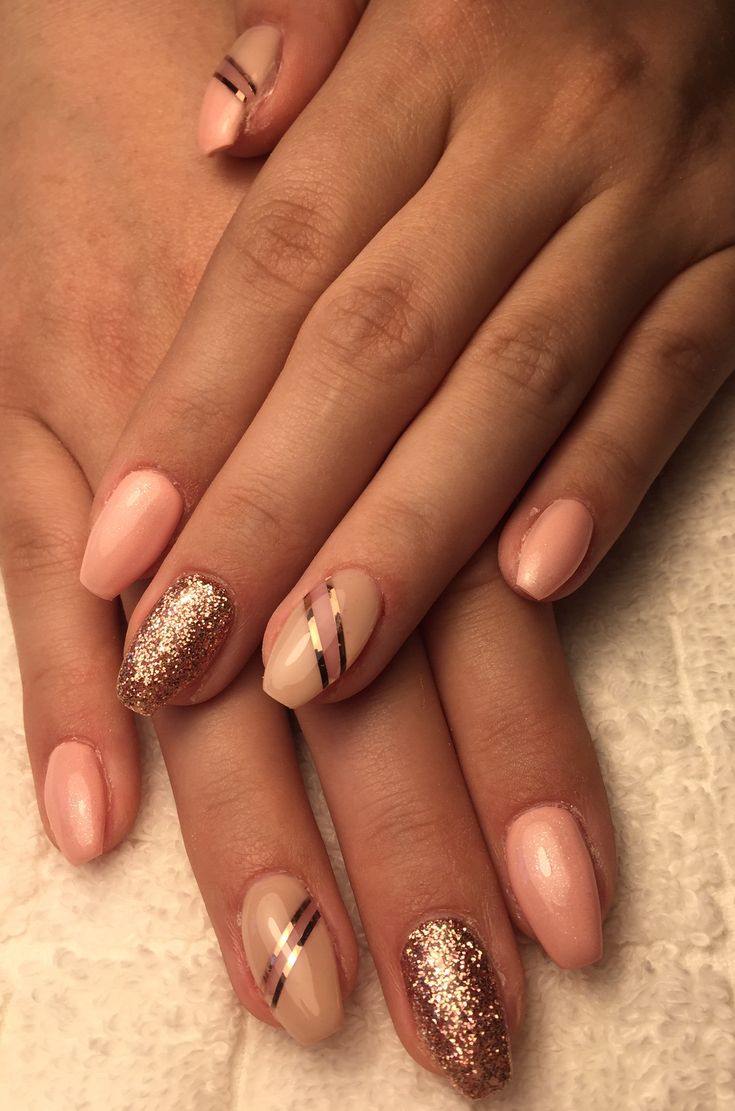 Chic Elegant Nail Design: Soft Pink Hues with Glitter and Gold Stripes.