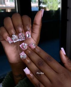 Chic Pink and White Nail Design with Elegant Rhinestones and Unique Patterns.