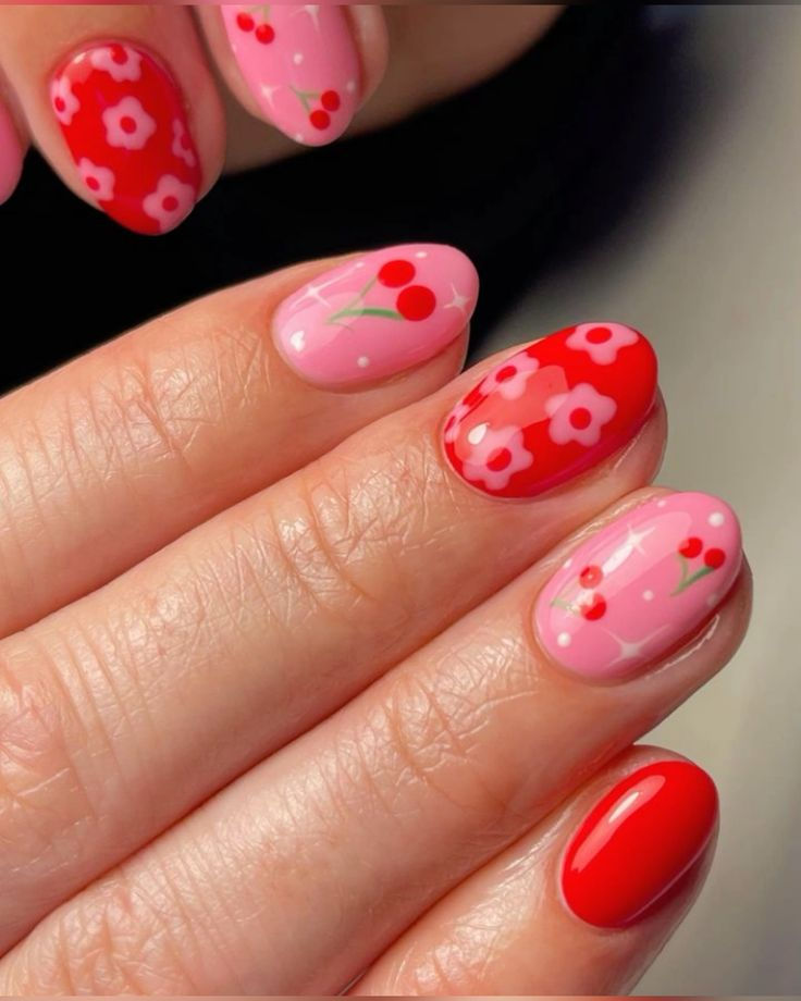 Vibrant Red and Pink Floral Nail Design with Cherry Motifs for a Cheerful Summer Aesthetic.