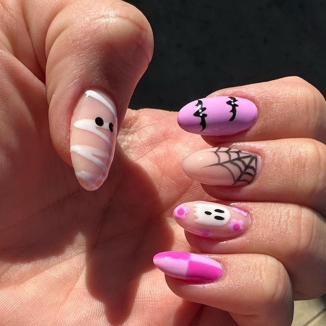 Whimsical Halloween Nail Art: Vibrant Colors and Spooky Characters.