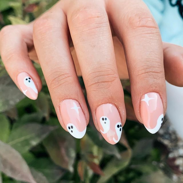 Charming Whimsical Ghost-Themed Nail Design with Soft Pink Base and Playful Accents.