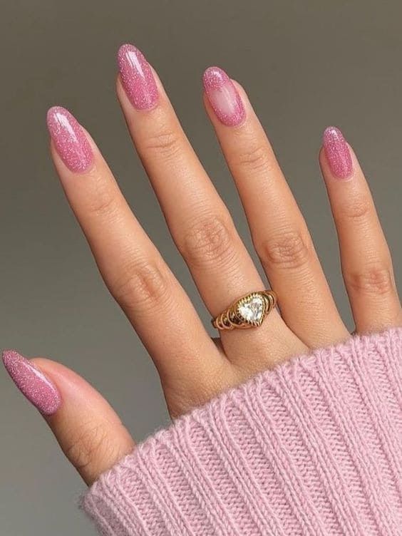 Chic Glittery Pink Ombre Nails Complemented by a Delicate Gold Ring.