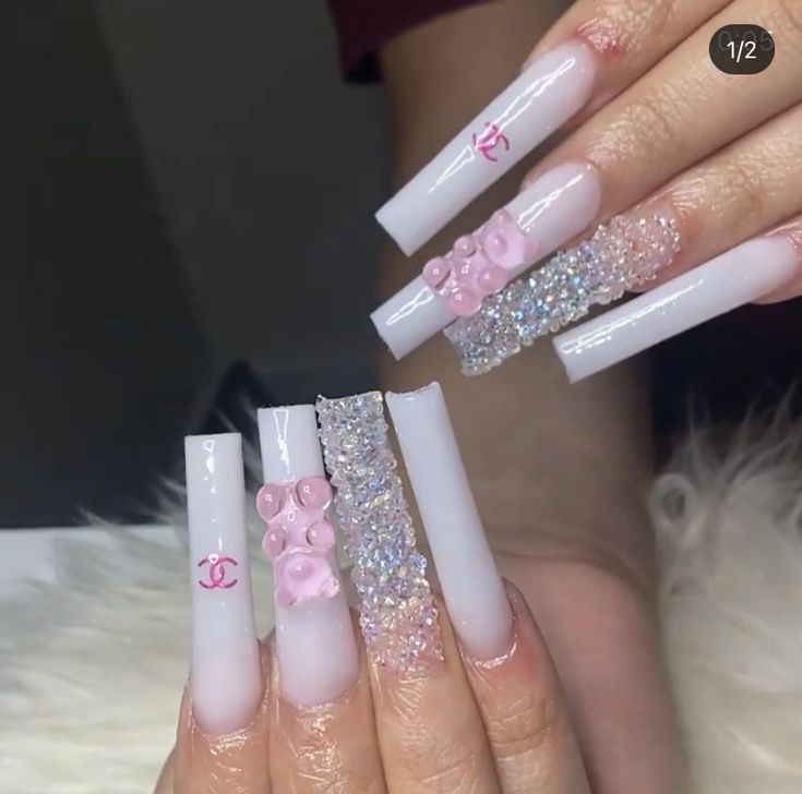 Elegant Long White Tip Nail Design with Playful Pink Accents and Sparkling Rhinestones.