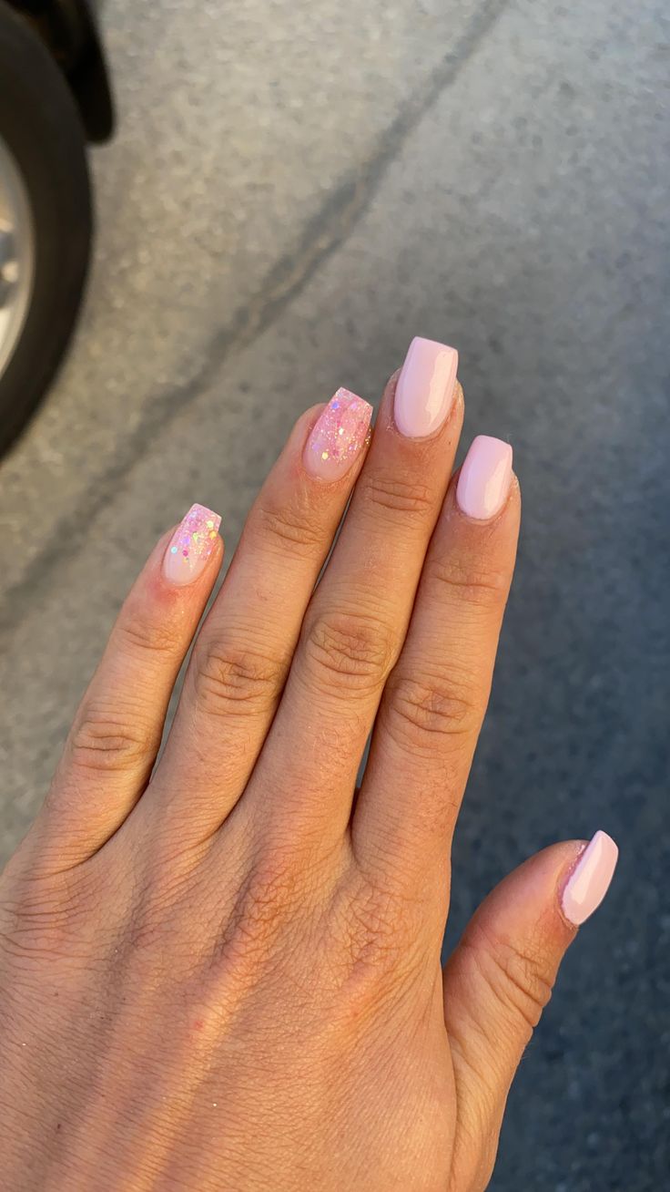 Elegantly Delicate Soft Pastel Pink Nails with Glitter Accents.