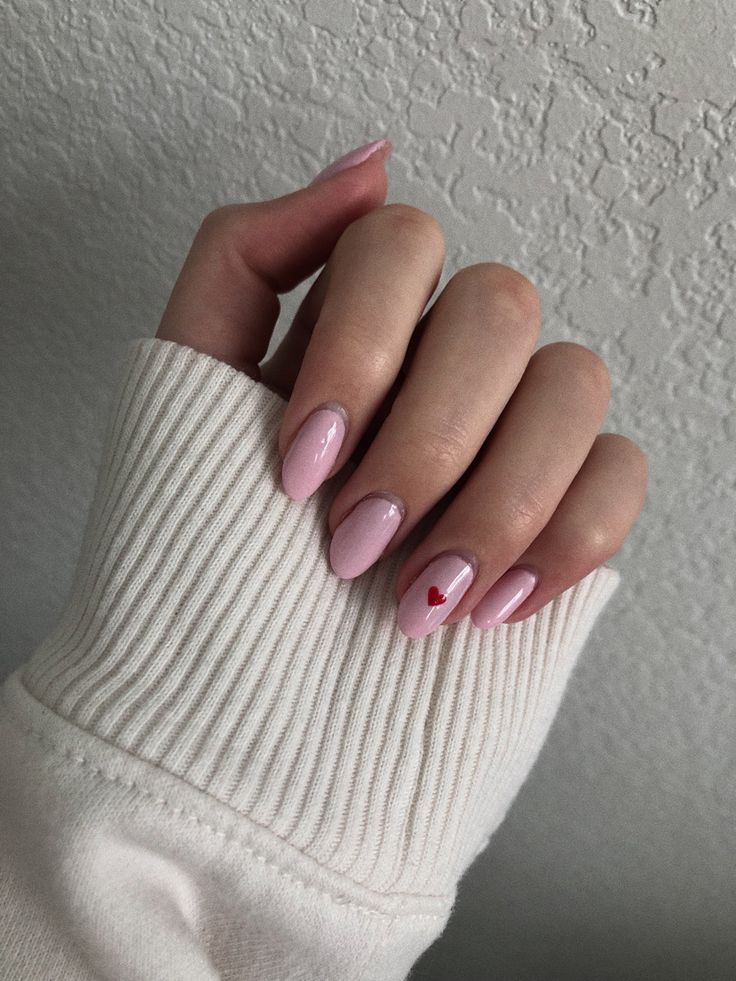 Chic Pink Matte Nails with Playful Heart Accent.