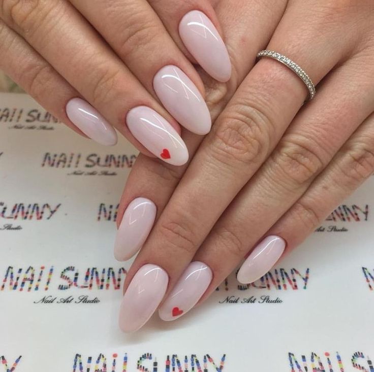 Elegant Soft Pink Almond Nails with Charming Red Heart Accents.