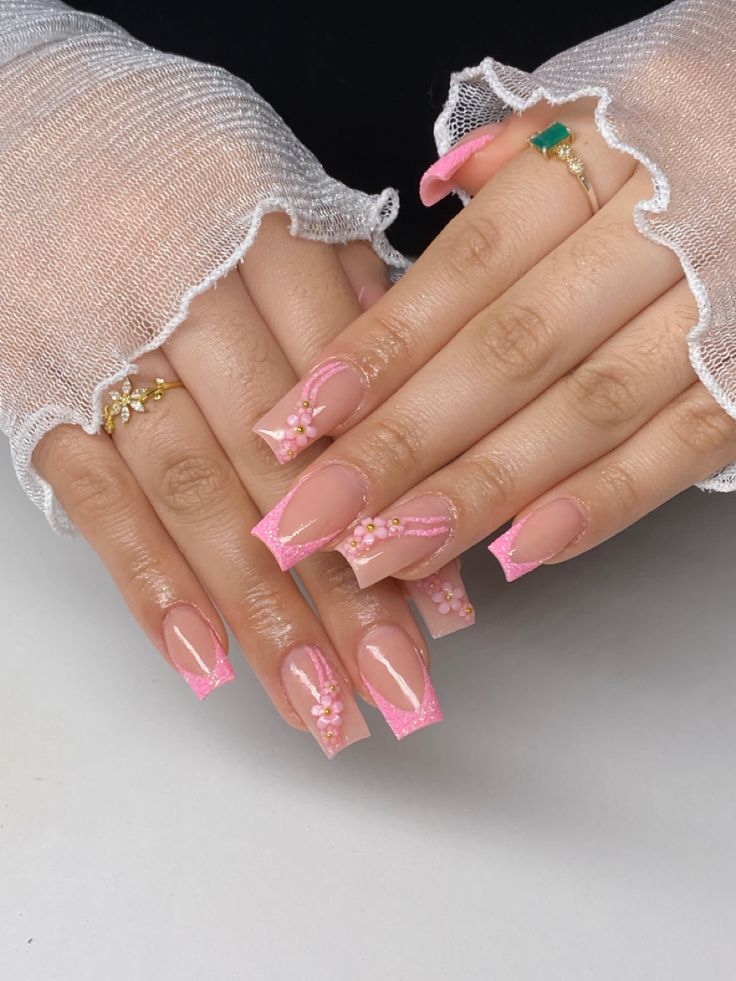 Chic Pink Nail Design with Glossy Tips and Floral Accents.