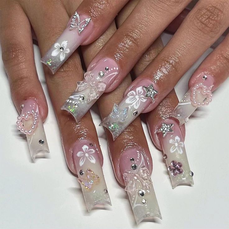 Chic Ombre Nail Design with Floral and Gem Embellishments