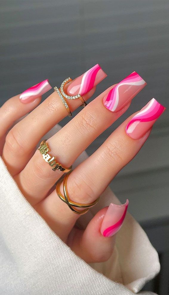 Chic Vibrant Pink Swirl Nail Design with Glossy Gradient and Gold Accents.