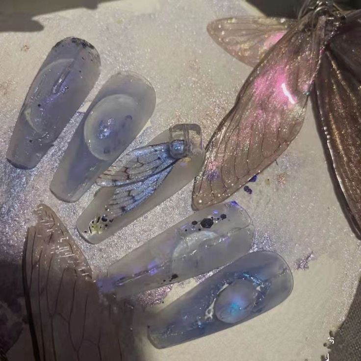 Whimsical Ethereal Nail Design with Translucent Tips and Butterfly Accents