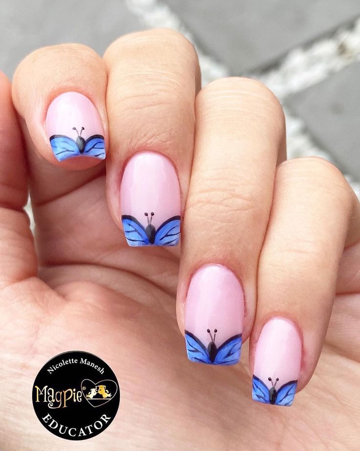 Delicate Blue Butterfly Nail Design on Soft Pink Base for a Fresh Spring Look.