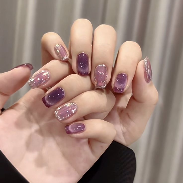 Elegant Ombre Nail Design with Shimmering Purple Hues and Chic Glitter Accents