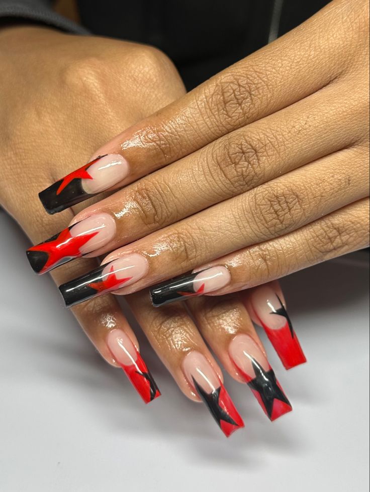 Bold and Dramatic Nail Design in Red, Black, and Nude with Striking Patterns.