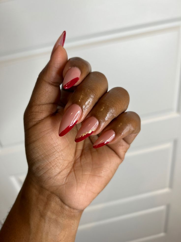 Chic Almond-Shaped Nails: Bold Red on Soft Nude with Glamorous Detailing