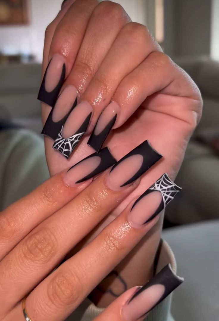 Elegant Dark Matte Black Nail Design with Spider Web Accents for a Bold Halloween Look.