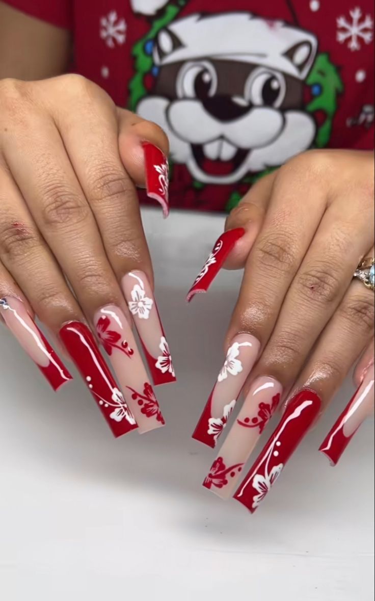 Elegant Holiday Nail Design: Vibrant Red and Nude with Intricate White Floral Patterns.